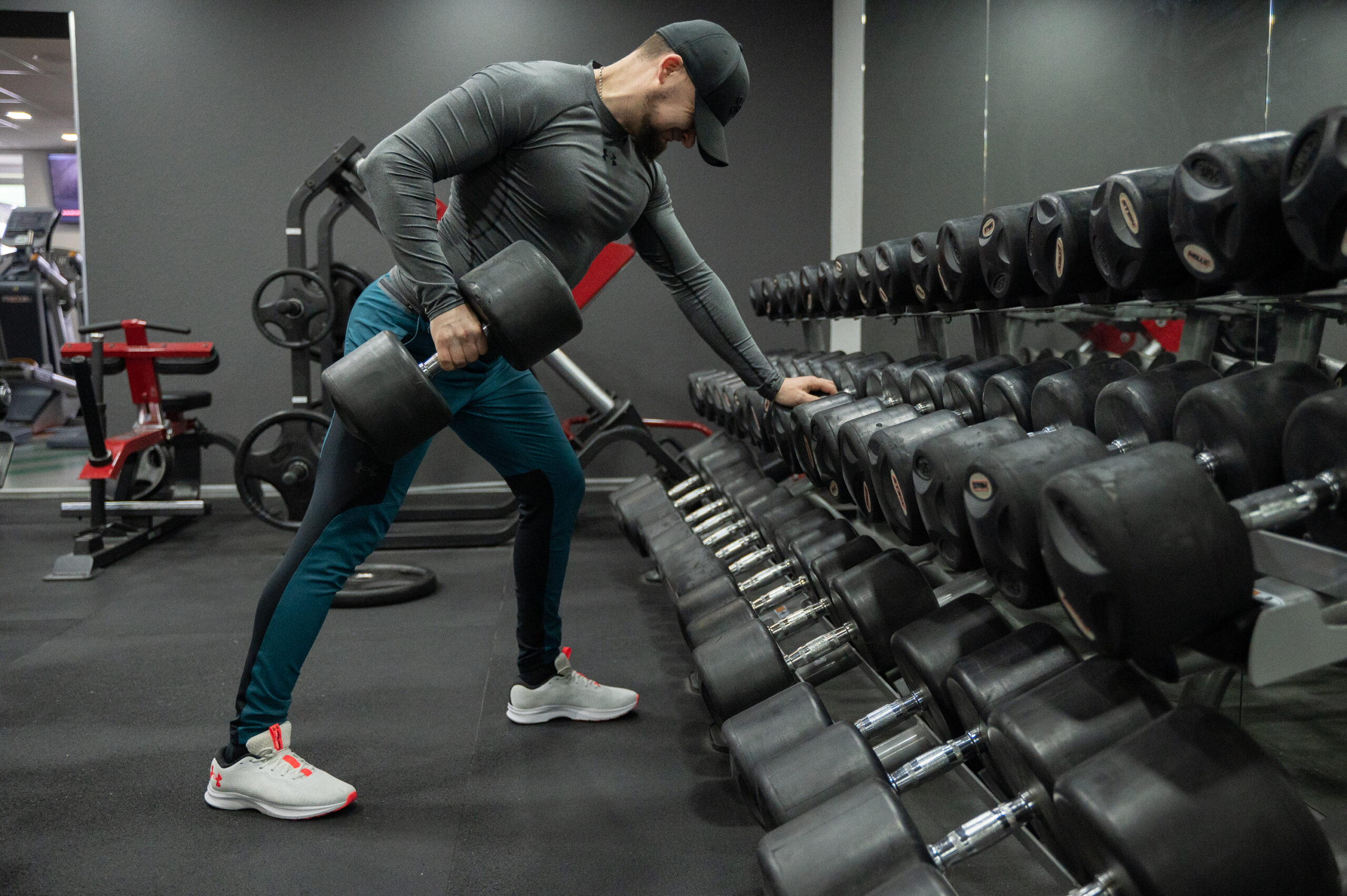 Athlete performing a focused strength workout with free weights in a modern gym