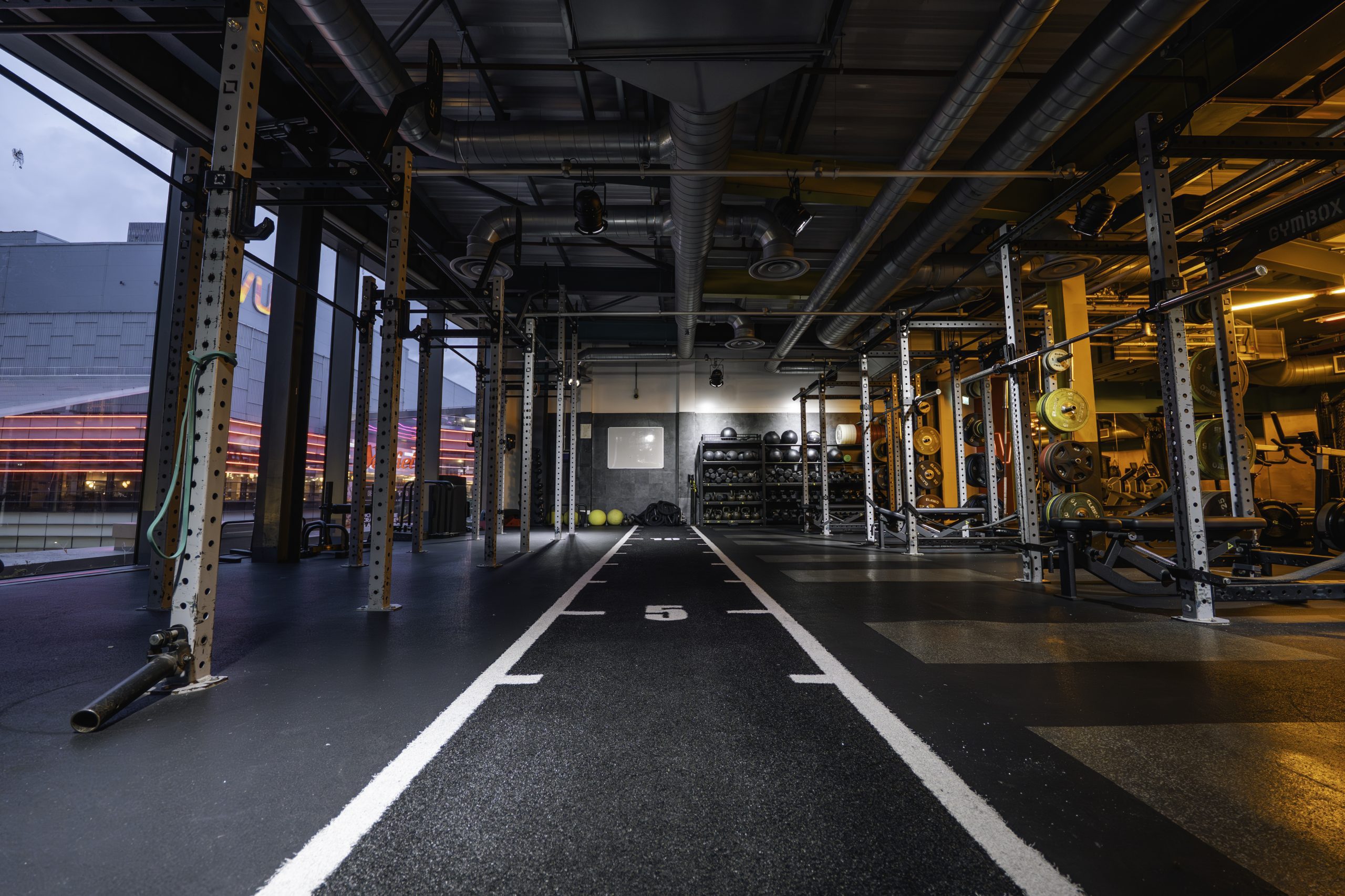Athlete performing controlled resistance training with free weights at ApexGym